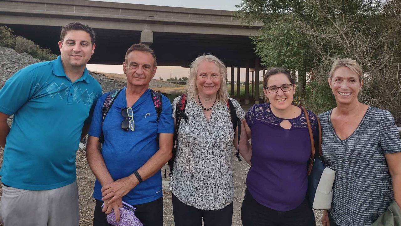 From left: Pam and Paul's son Kevin Gietzel, Paul Gietzel, Pam Cook, Kevin's wife Sandy Rogers, and Dr. Christine Kreuder Johnson. Five people standing outside.