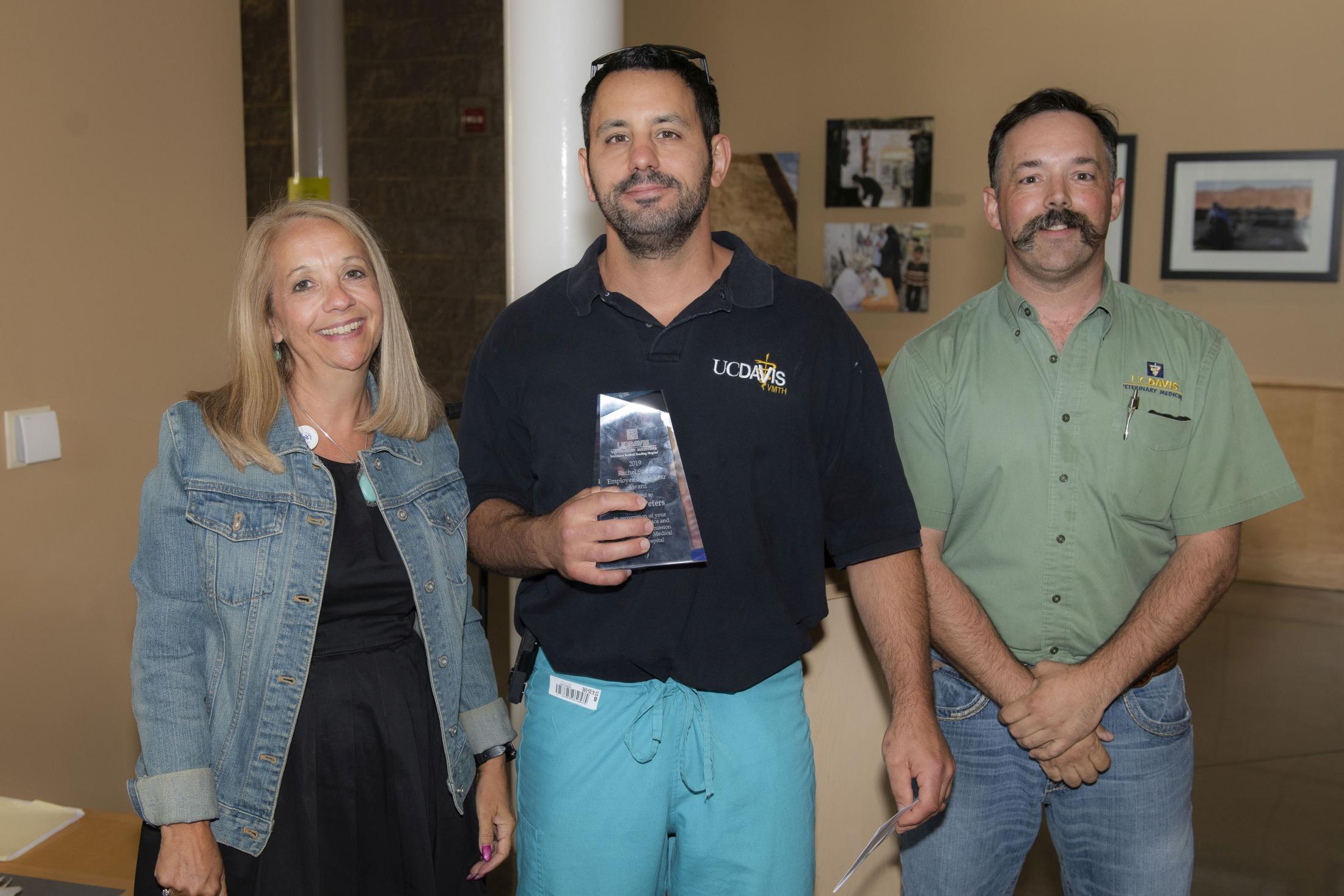 Jason Peters, RVT, RLAT, (center) with VMTH Hospital Administrator Joy Hoover and faculty member Dr. Bret McNabb.