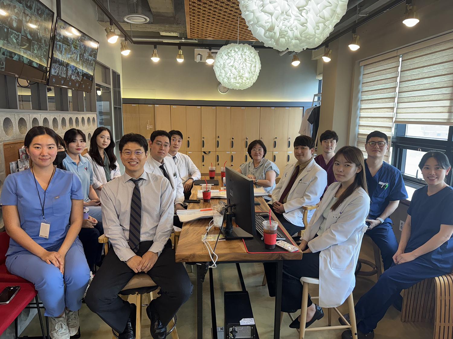 A group of people posing at a meeting table.
