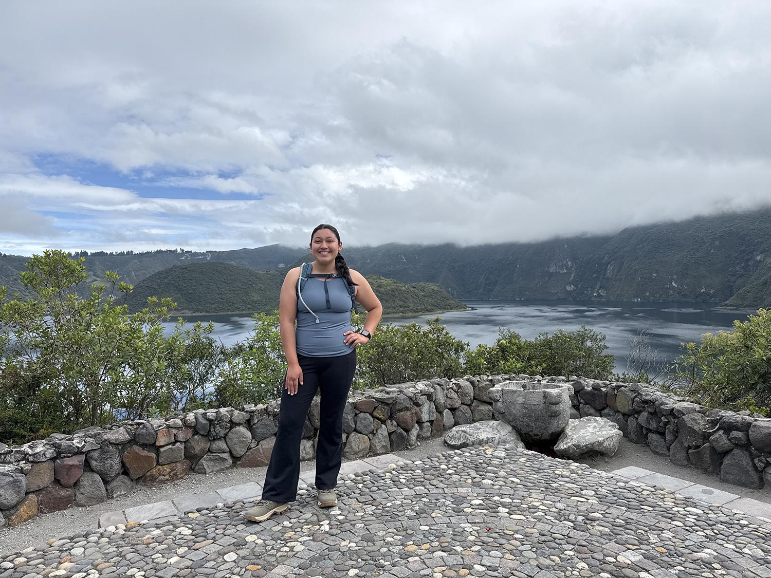 Gloria posing in front of a lake.