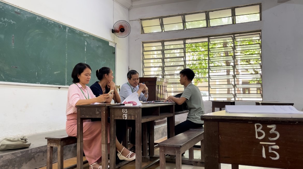 Nhung sitting in a classroom.