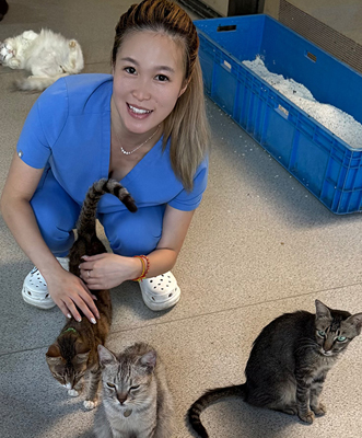 Betty Yang with cats.