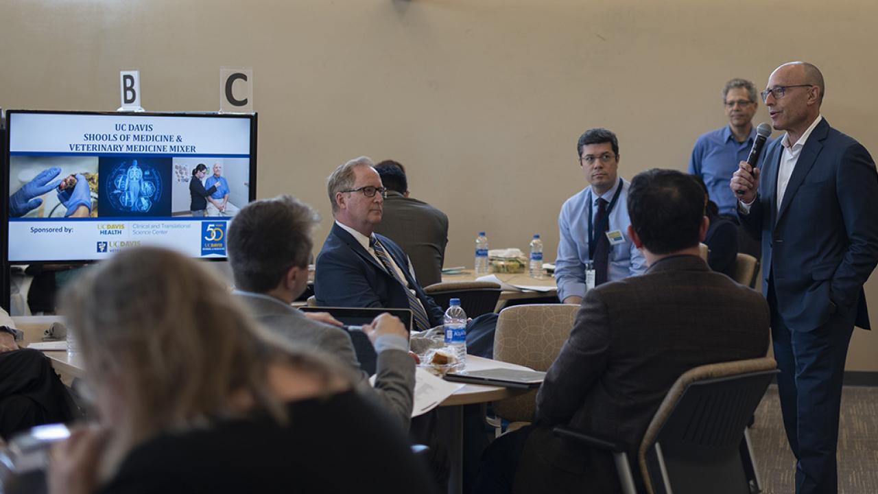 UC Davis Health Vice Chancellor David Lubarsky addresses faculty members. people talking in a meeting