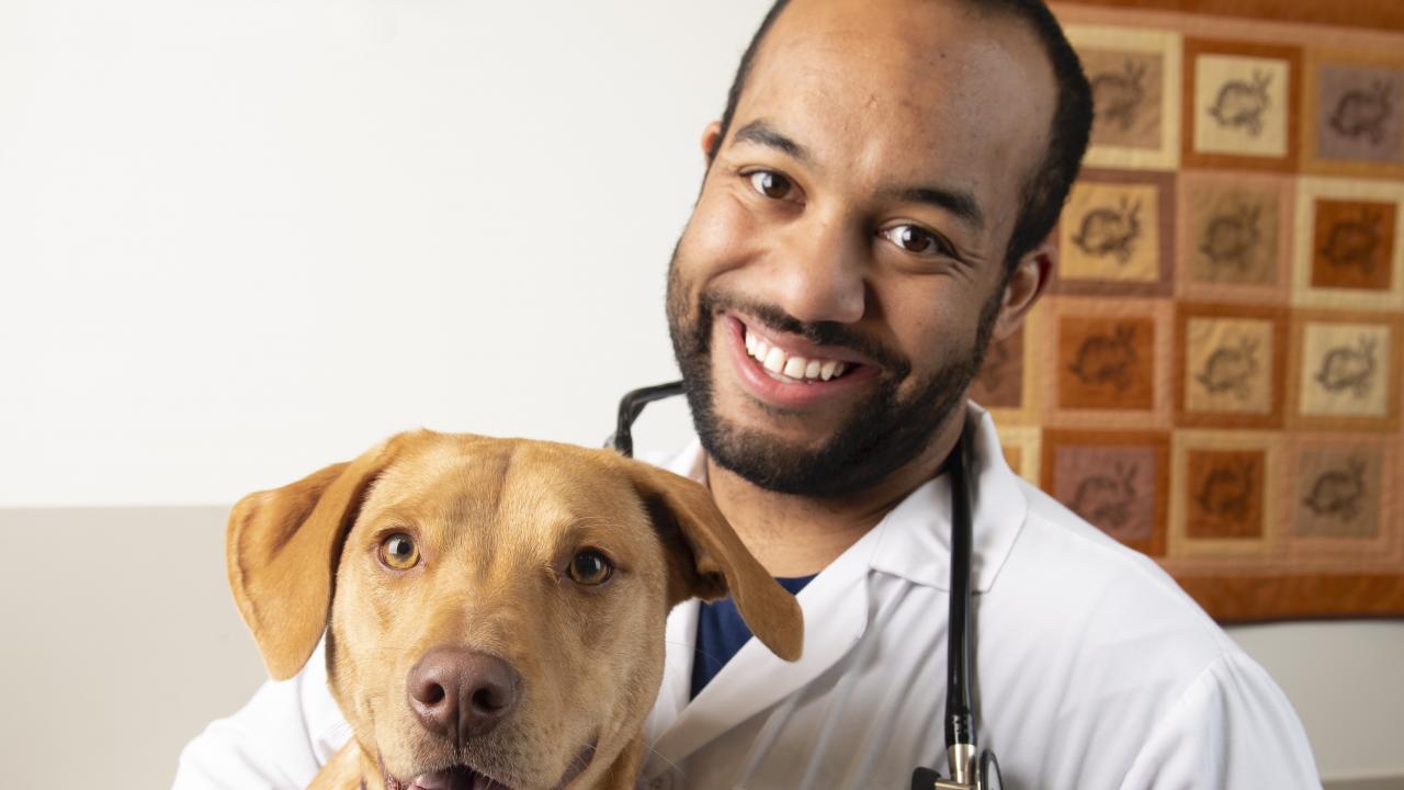 Student Sean Gadson with Lucy the dog.