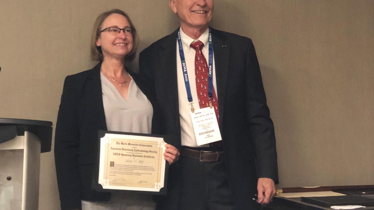 Dr. Ashley Hill receiving the award from Dr. Craig Carter, President of the AVES.