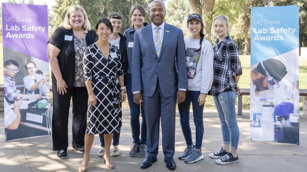 group of lab personnel with Chancellor May