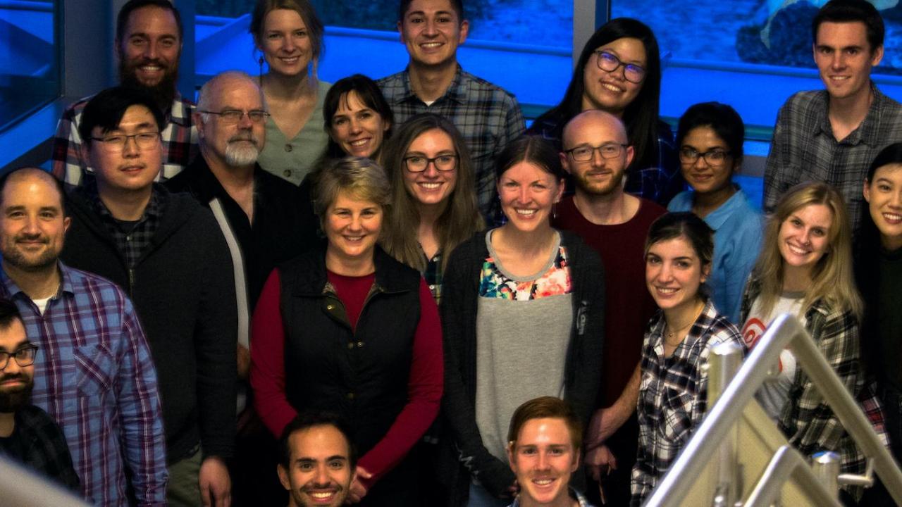 Dr. Pam Lein (in red with black vest) with members of her lab lein lab