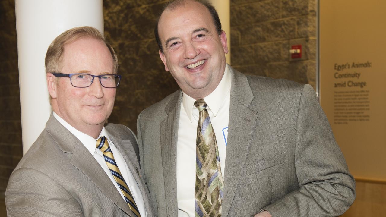 Dr. Tom Campi (right) receives his award from Dean Michael Lairmore.