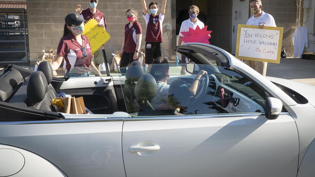 The Class of 2024 received white coats and goodie bags in a drive-through process. white coat drive thru