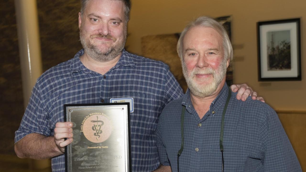 Dr. Peter Havel (right) receives his award from Dr. Kevin Woolard.