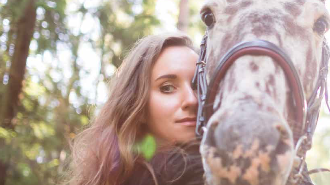 woman hugging a horse, image from modern equine vet magazine