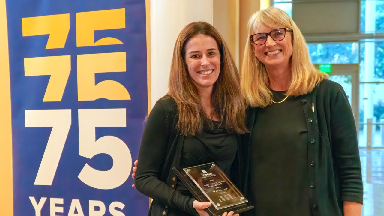 Dr. Heather Knych (left) receives her award from Dr. Joie Watson