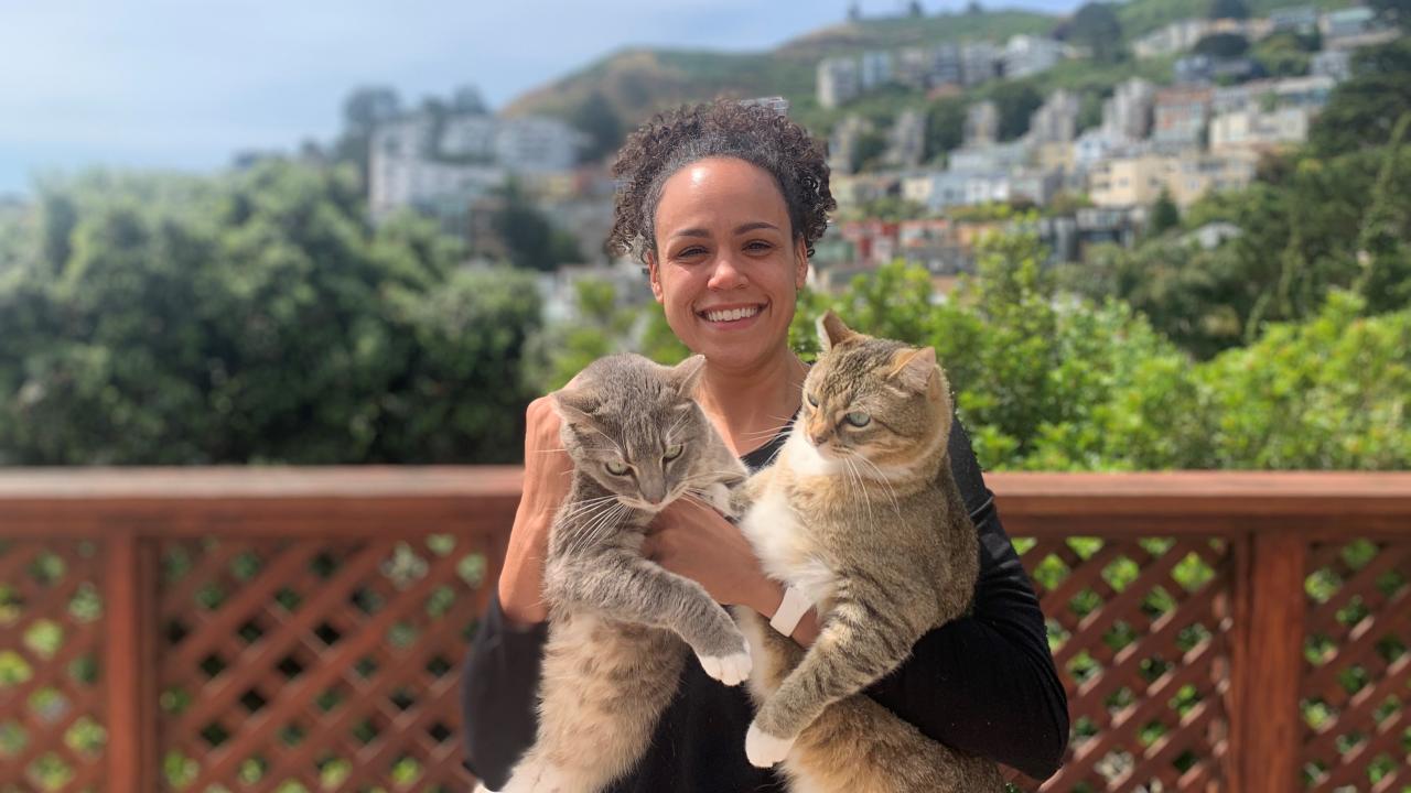 student holding cats