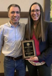 Drs. Mathieu Spriet (left) and Sabrina Wilson with Dr. Wilson's Resident Author Award.