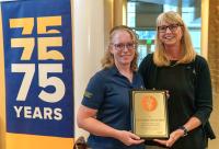 Dr. Julie Dechant (left) receives her award from Dr. Joie Watson.