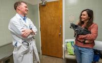 veterinarian talking with client holding her dog