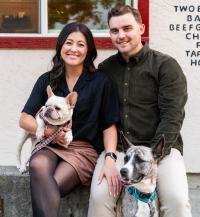 couple sitting with dogs