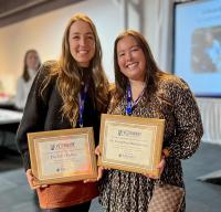 two veterinarians with awards