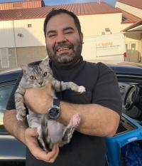man holding healthy looking cat