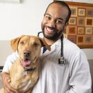 Student Sean Gadson with Lucy the dog.