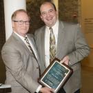 Dr. Tom Campi (right) receives his award from Dean Michael Lairmore.