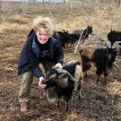 Tracey Stevens offers feed to rescued San Clemente Island goat at Sabatka Farms in Weston, NB, following devastating floods