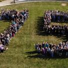 drone photo of people in shape of 75