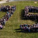 overhead view of people forming the number 75