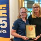 Dr. Julie Dechant (left) receives her award from Dr. Joie Watson.