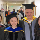 four veterinarians in graduation caps and gowns