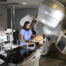 veterinary student assists a dog receiving a radiation treatment on the linear accelerator at the UC Davis veterinary hospital