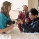 student and professors examining a cat's eye