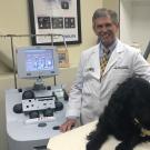 veterinarian with a dog and hemodialysis equipment