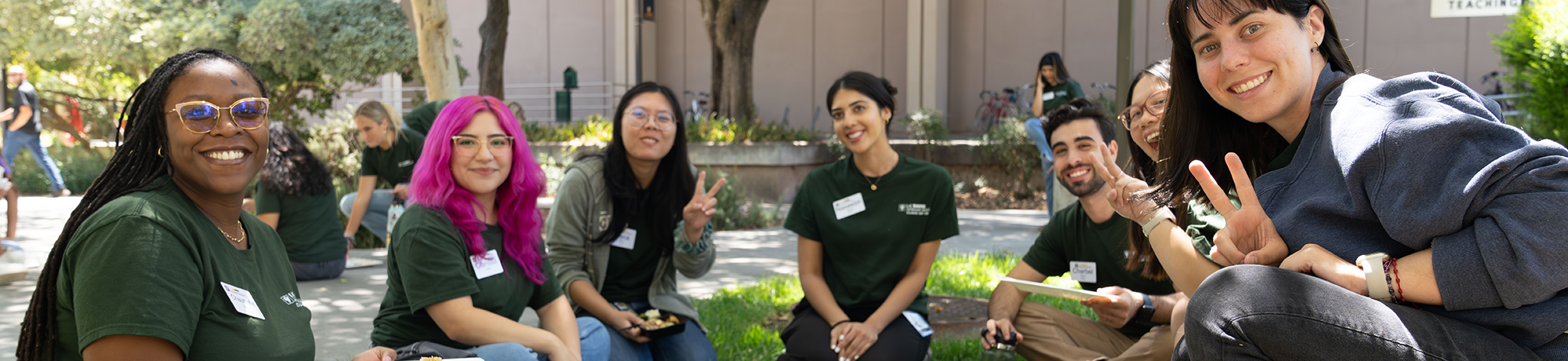 A group of students gathering for lunch on the lawn in front of the Veterinary Medical Teaching Hospital.